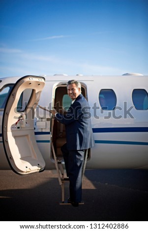 Businessman about to board a private jet
