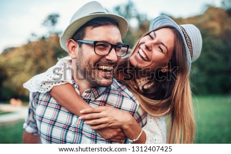 Couple in love. Boyfriend carrying his girlfriend on piggyback. Love and tenderness, dating, romance. Lifestyle concept Royalty-Free Stock Photo #1312407425