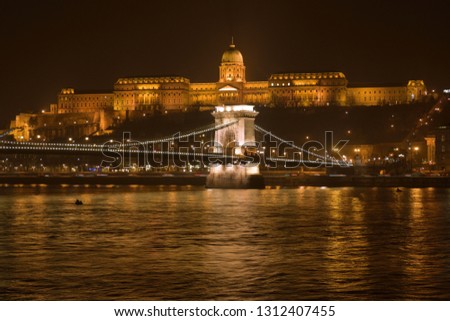 View of Budapest at a misty night from Danube bank.
