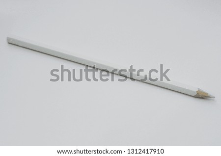 white long pencil lies on white paper