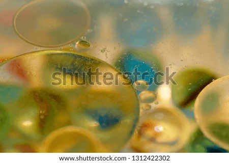 floating in the water abstract colorful, yellow oil drops.