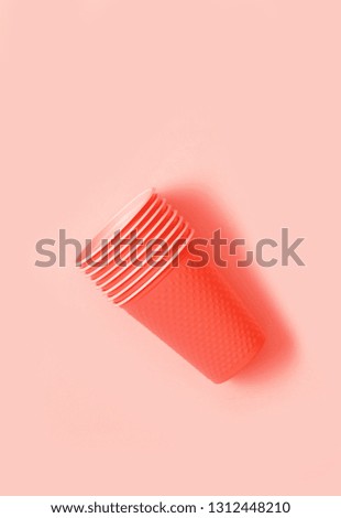 Plastic cups on coral background. Ecology concept.