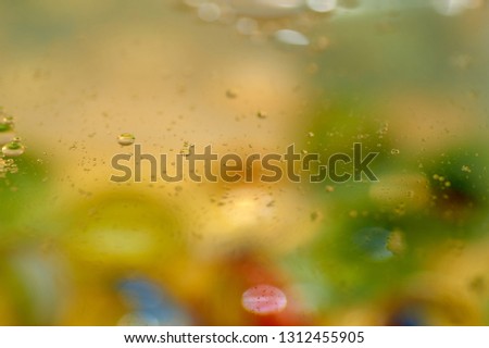 floating in the water abstract colorful, yellow oil drops.