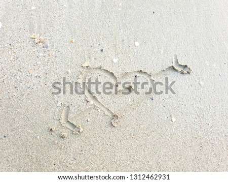 Drawing hearts on the sand beach, Sandy beach for background, Top view, space for your text, Valentine Day design, Love concept, greeting card, postcard, wedding invitation