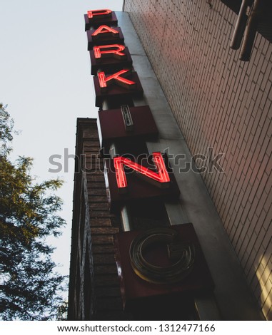 Red neon vertical parking sign