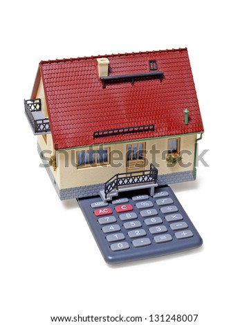 Model house and calculator on white background