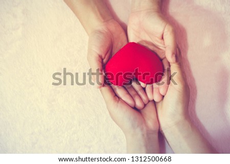 Group of hands holding red heart for V-Day love for valentine concept.