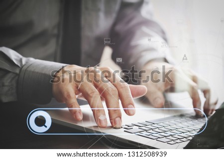 Searching Browsing Internet Data Information Networking Concept with blank search bar.businessman working with laptop computer on wooden desk in modern office with virtual icon diagram