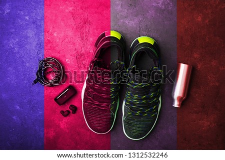 Sneakers, headphones, water bottle. The concept of the sport of life in motion. Fashionable retro wave of bright paints photo processing toning. Bright nostalgic style. Toning,