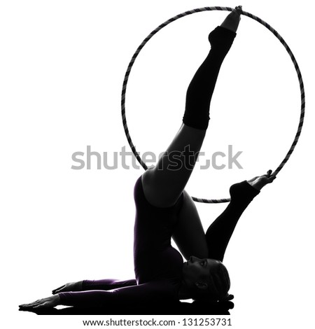 one caucasian woman exercising Rhythmic Gymnastics hula hoop  in silhouette studio isolated on white background