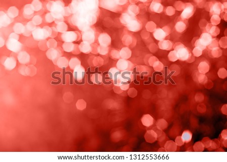 Photo Bokeh abstraction Living coral - the color of the year 2019. Gorgeous Christmas lights. Holiday concept,