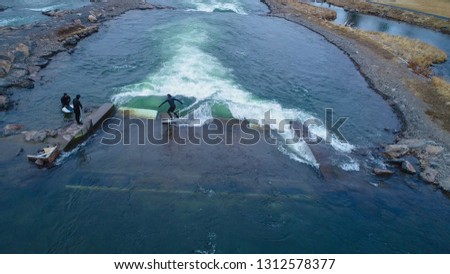 Aerial drone photo of surfers at the Bend Whitewater Park in Bend, Oregon. Royalty-Free Stock Photo #1312578377