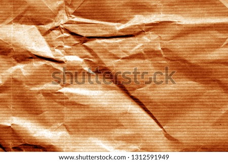 Crumpled sheet of paper in orange color. Abstract background and texture for design.