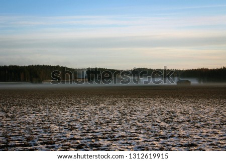 Scenic view of sunset and mist on fields, South Finland