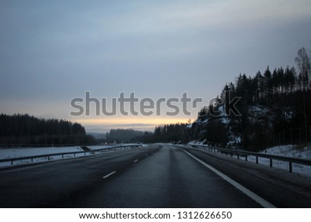 Scenic misty winter road in Finland view with rocks and tunnels