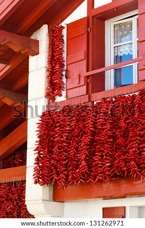 A typical basque frontage with bunches of drying red pappers. Royalty-Free Stock Photo #131262971
