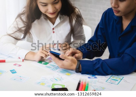 Group of people designers mobile application working wireframe sketch drawing application in office. Teamwork  user experience Design concept.