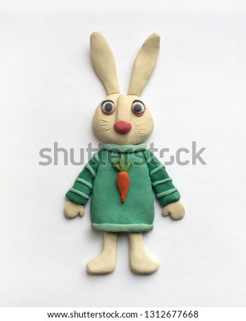 Cute hare in a blue dress. Plasticine character on a white background Royalty-Free Stock Photo #1312677668