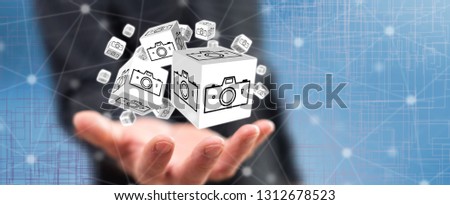 Pictures sharing concept above the hand of a man in background