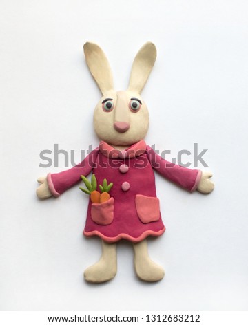 Cute hare in a pink dress. Plasticine character on a white background Royalty-Free Stock Photo #1312683212