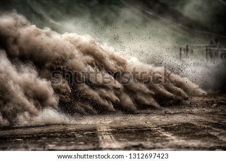 racing sports car in dust clubs on the track , rally  Royalty-Free Stock Photo #1312697423