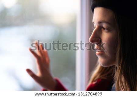 girl is looking out the window