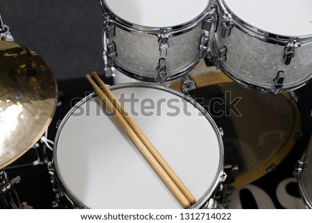 Drums conceptual image. Picture of drums and drumsticks lying on snare drum