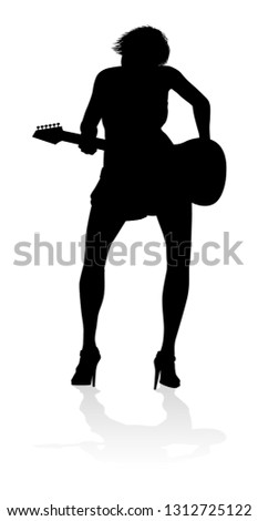 A female guitarist musician in detailed silhouette playing her guitar musical instrument.