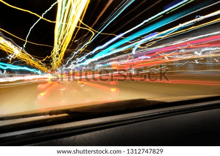 Abstract shot of city and traffic lights from inside of the car. Concept of speed, fast motion and time traveling

