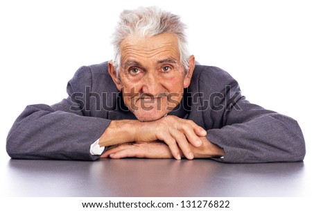 Portrait of a smiling old man looking at camera against white background