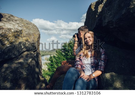 Happy young couple in mountain.  Hipster couple in love having fun together.