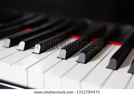 Closeup of piano keys with red stripe - music concept