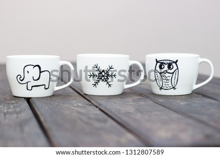 White ceramic mugs with permanent marker drawing on wooden table diy cup gift handmade sharpie mugs personalised party favors