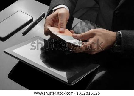 Businessman is performing bank transactions in office