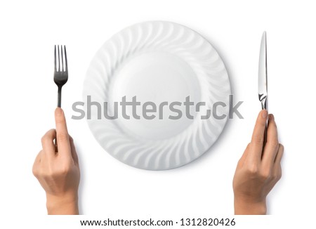 Woman hands holding a silver fork and knife isolated on white