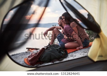 View from tent of couple lying a view of lake during hiking trip. avel Lifestyle concept adventure vacations outdoor.
