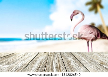 desk of free space and beach landscape with flamingo bird 