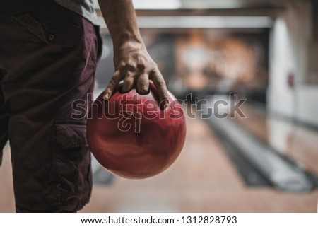 A close-up of a hand with bowling ball  in a bowling alley. Bowling night