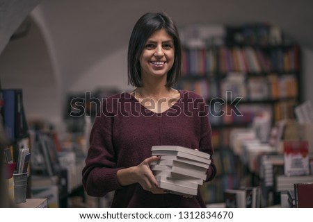 Portrait of beautiful woman bookshop owner. Successful independent businesswoman, owner of a book shop Royalty-Free Stock Photo #1312834670