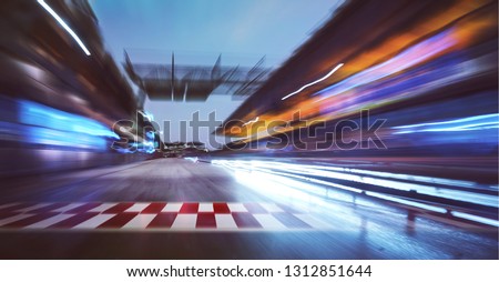 Motion blurred racetrack with start or end line and  lighting effect apply . Royalty-Free Stock Photo #1312851644