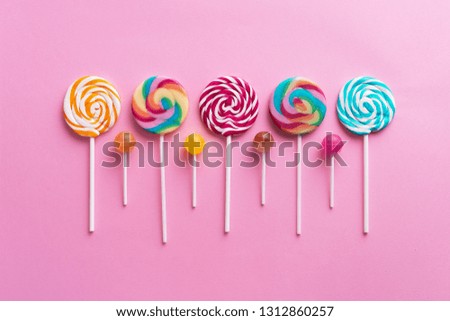 Multiple colorful candies organized over pink background