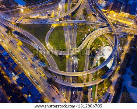 Aerial view of high-level highway interchange at dusk with blurred moving vehicles

