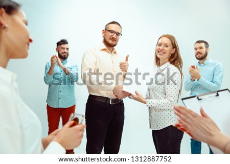Boss approving and congratulating young successful employee of the company for her successes and good work. National Employee Appreciation Day, businesswoman, businessman, business, success, admire