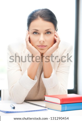 picture of bored and tired woman behid the table