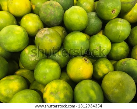 Healthy organic green oranges fruit at the market 