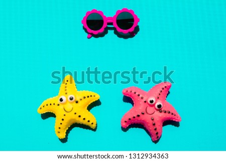 Two starfish and sunglass on blue background. Summer Holiday Banner.