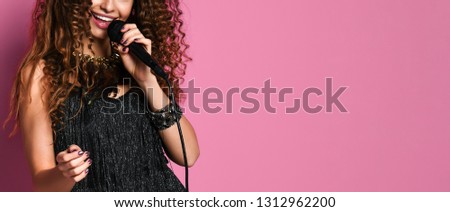 Singer. young pretty brunette woman singing in microphone isolated close up