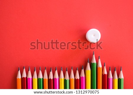 Colorful pensil and a glue shot on a plain isolated red background as wallpaper.