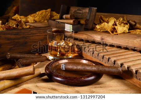 Cigars and Whiskey on wooden Background Royalty-Free Stock Photo #1312997204