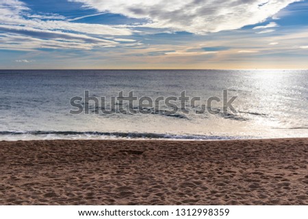 Mediterranean beach seascape on a cloudy sunrise landscape
